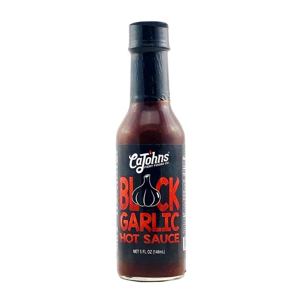 Bottle of CaJohn's Black Garlic Hot Sauce on a white background