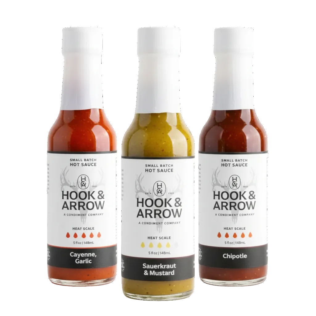 Three bottles of Hook & Arrow hot sauce on a white background
