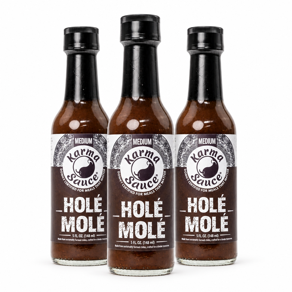 Three bottles of Karma Sauce Hole Mole Hot Sauce