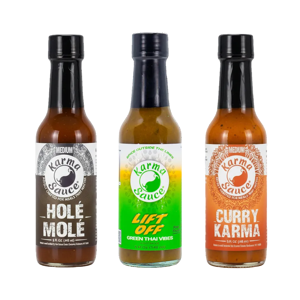 Three bottles of Karma Sauce with different flavors on a white background