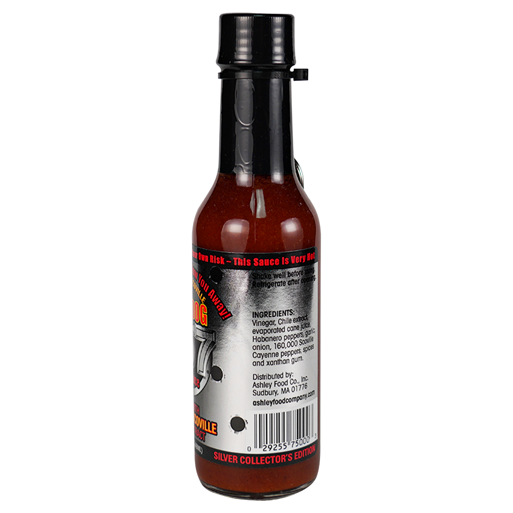 Back view of a hot sauce bottle on a plain white background, showing the label text and barcode. The bottle contains a dark reddish-brown sauce and has a black cap.
