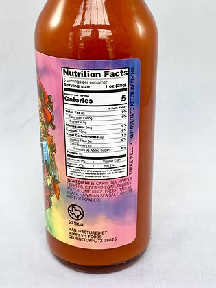 Hot sauce bottle with nutrition label on a white background