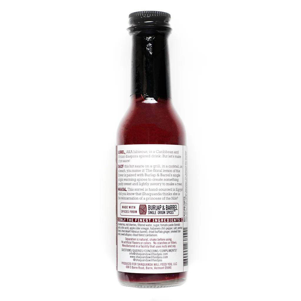 Bottle of Shaquanda's Sorrel hot sauce with a label on a white background