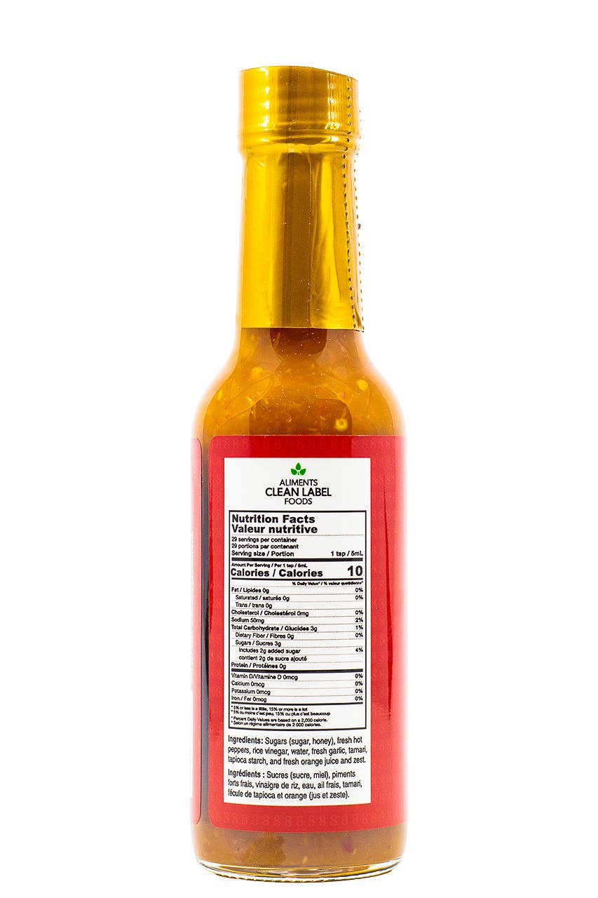 Bottle of 8 Dragons hot sauce with a gold cap and red label on a white background