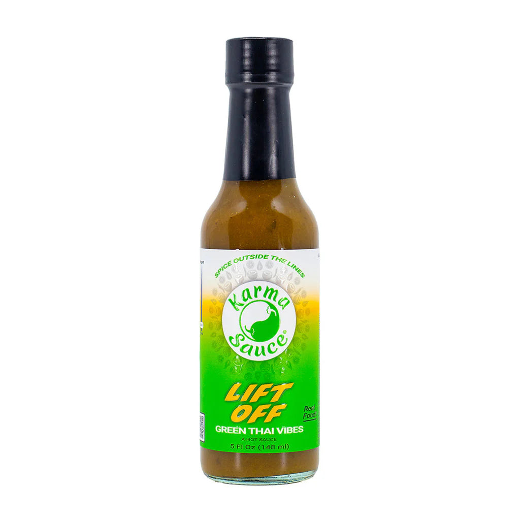 Bottle of Karma Sauce with green label on a white background