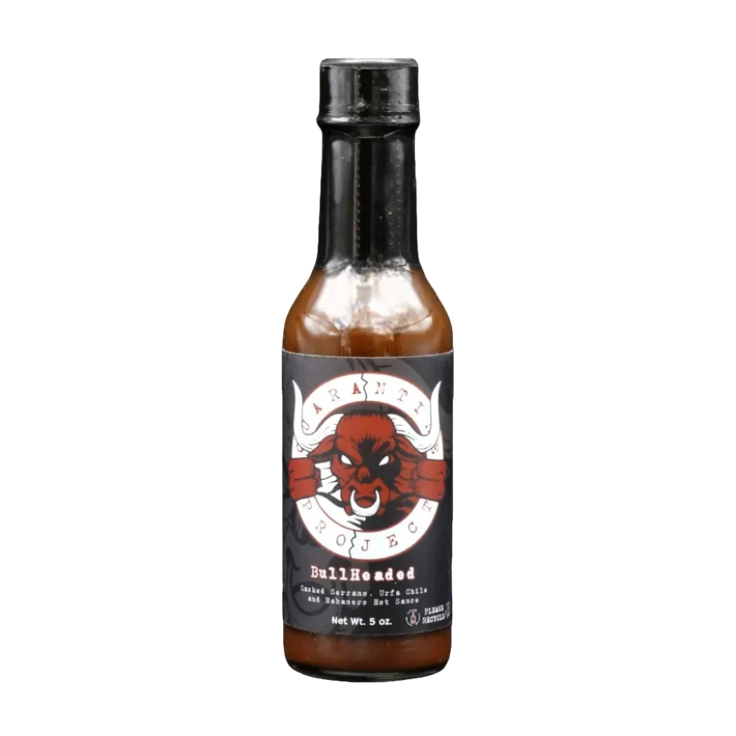 Hot sauce bottle with a black label featuring a red and white design on a white background