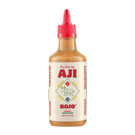 Bottle of Aji Rojo sauce with a red cap on a white background