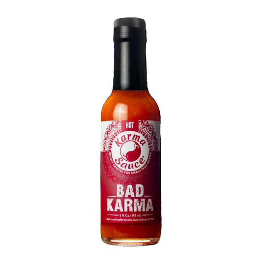 Bottle of Bad Karma hot sauce on a white background