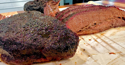 Smoked meat on a cutting board with a blurred background