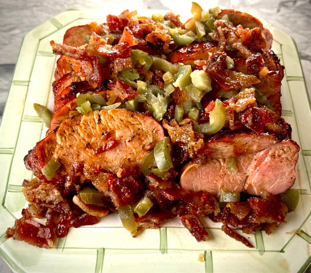 Plated dish of roasted meat with vegetables on a checkered tablecloth