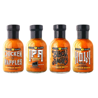 Four bottles of Blonde Beards Buffalo sauce with different flavors on a white background