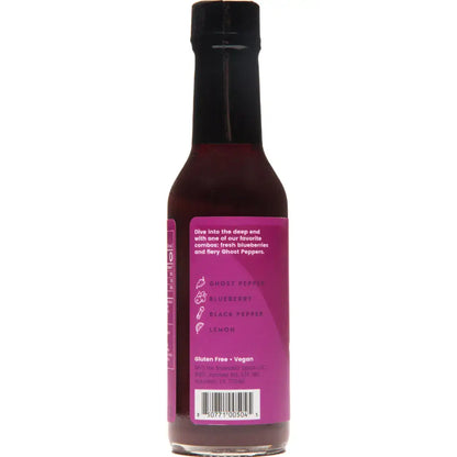 Bottle of Bravado hot sauce with a purple label on a white background