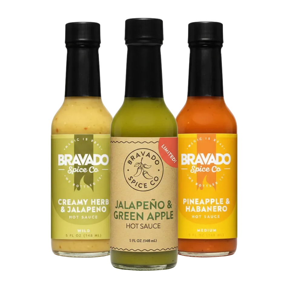 Three bottles of Bravado fruity hot sauces on a white background