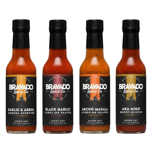 Four bottles of Bravado Spice Co hot sauce on a white background
