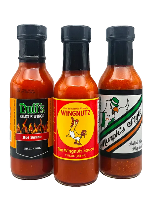 Three bottles of hot sauce with visible labels on a white background
