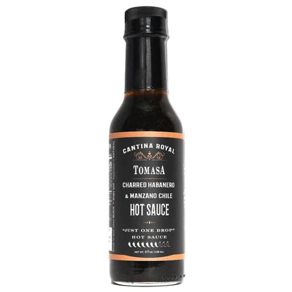 Bottle of Tomasa hot sauce with a black label on a white background