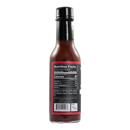 Bottle of hot sauce with nutrition facts label on a white background