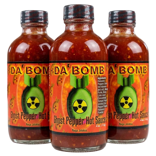 Three bottles of 'Da Bomb Ghost Pepper Hot Sauce' on a white background
