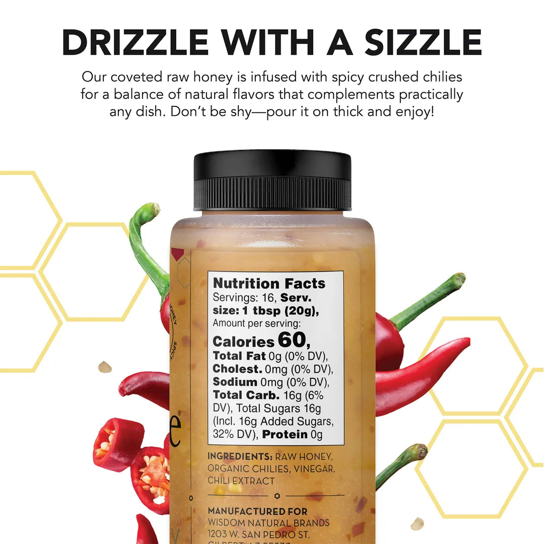 Bottle of spicy honey with nutrition facts label, surrounded by chilies on a white background.