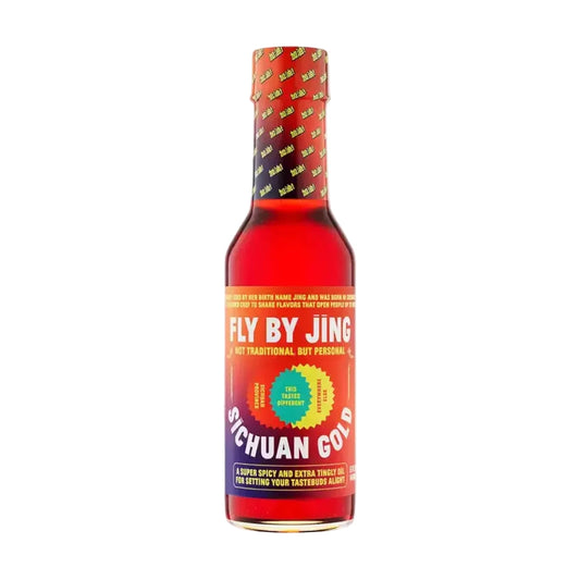 Bottle of Fly By Jing Sichuan Gold hot sauce on a white background
