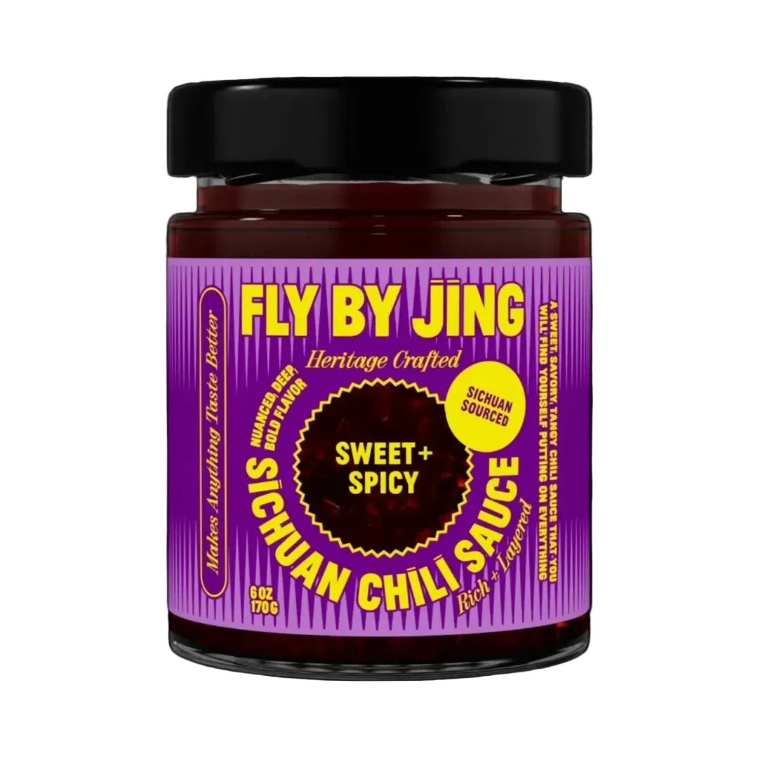 Jar of Fly By Jing Sichuan Chili Sauce with purple label and black lid on white background