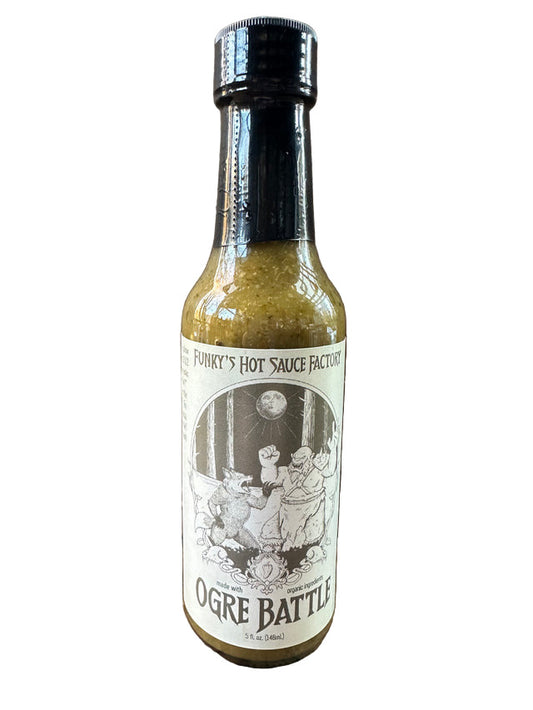 Hot sauce bottle labeled 'Ogre Battle' from Funky's Hot Sauce Factory on a wooden surface.