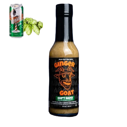 Bottle of Ginger Goat Hoppt Sauce with a can of beer and hops on a white background