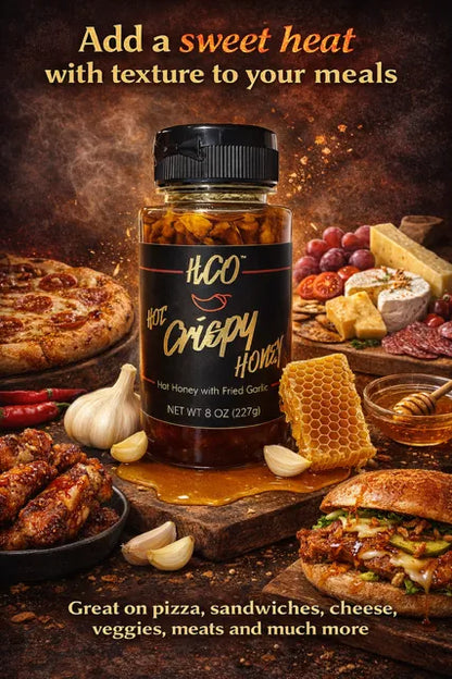 HCO Hot Crispy Honey jar with food items like pizza, wings, and a sandwich on a wooden board.