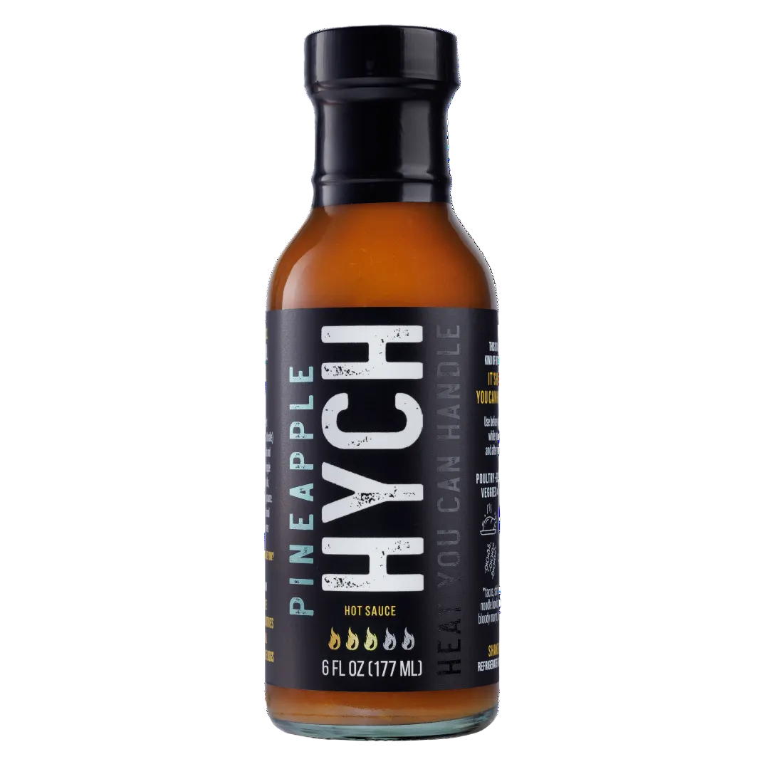 Bottle of HYCH pineapple hot sauce with black label on a white background