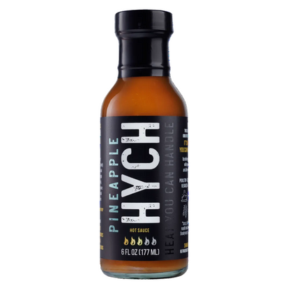 Bottle of HYCH pineapple hot sauce with black label on a white background