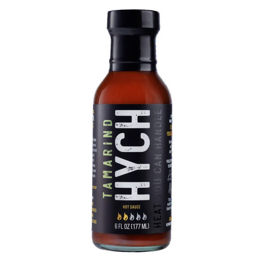 Bottle of HYCH hot sauce with a black label on a white background