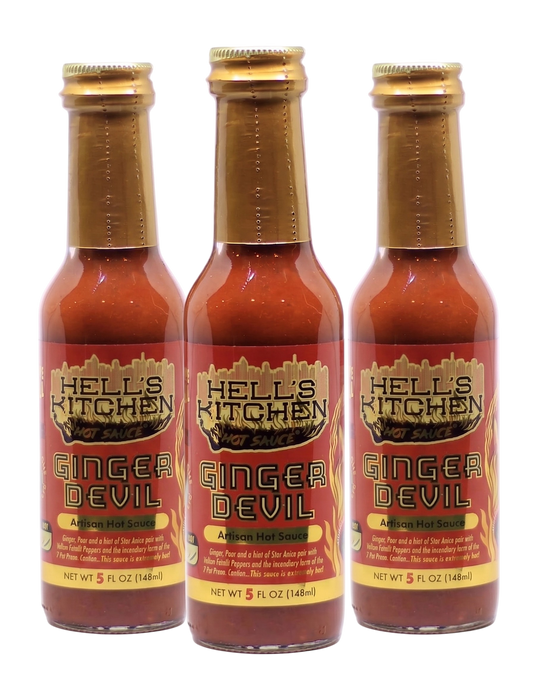Three bottles of Hell's Kitchen Ginger Devil Afzain Hot Sauce arranged side by side on a white background.