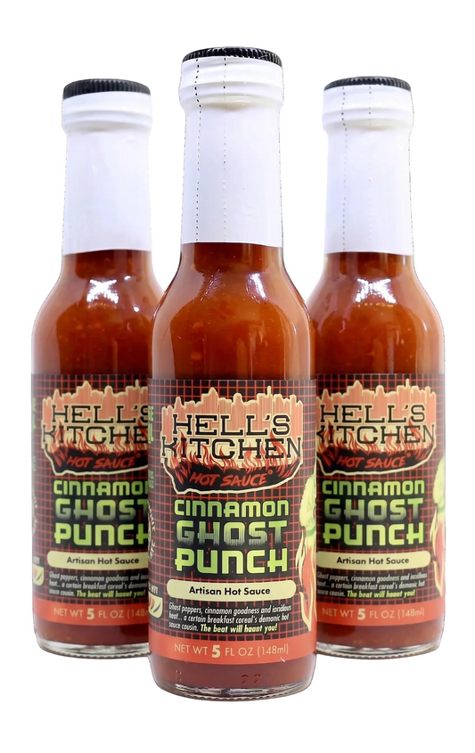 Three bottles of Hell's Kitchen Cinnamon Ghost Punch Artisan Hot Sauce arranged in a row on a white background, with the center bottle in sharp focus and the two behind it slightly blurred.