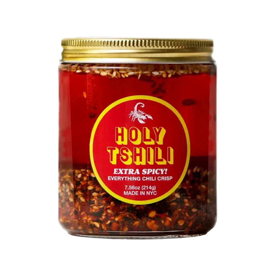 Jar of 'Holy Tshili' chili crisp with a red label on a white background