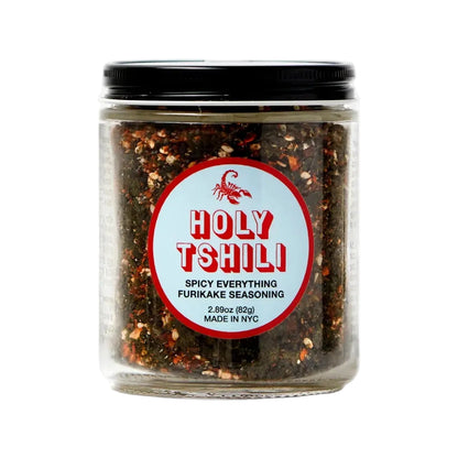 Jar of 'Holy Tshili' spicy seasoning with a red label on a white background