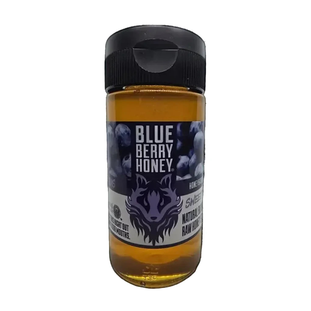 Bottle of Blue Berry Honey with a black cap on a white background