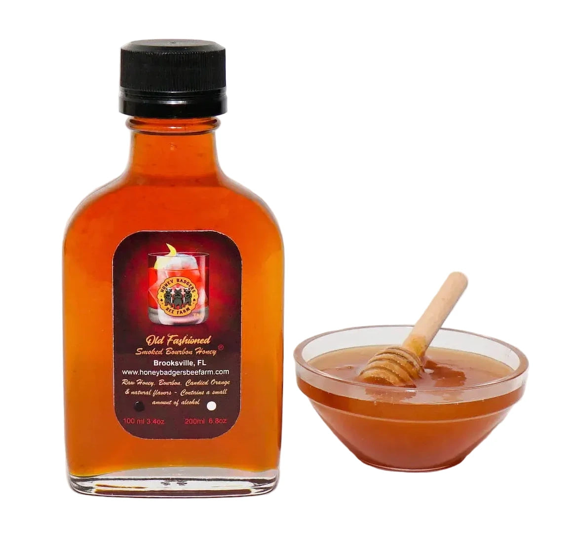 Bottle of honey with a label and a bowl of honey with a dipper on a white background