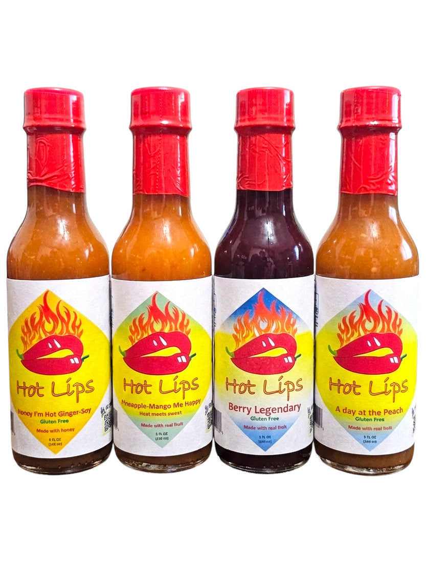 Four bottles of Hot Lips hot sauce with red caps on a white background
