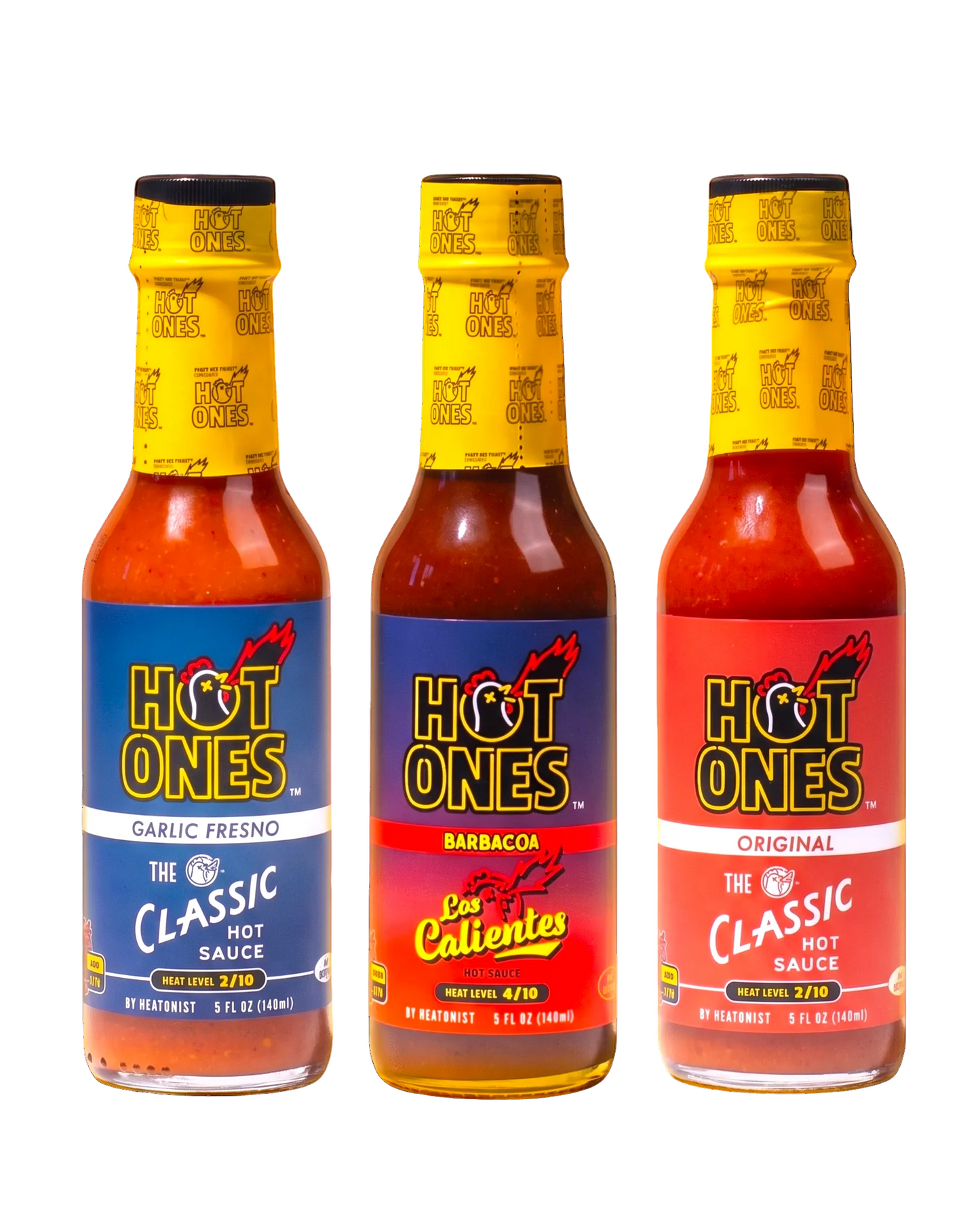 Three bottles of Hot Ones hot sauce with different flavors on a white background