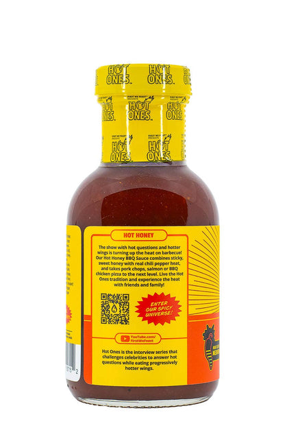 Hot Ones hot sauce bottle with yellow cap and label on a white background