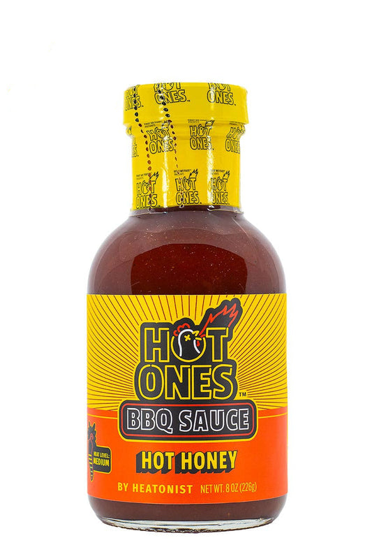 Bottle of Hot Ones BBQ Sauce with yellow and orange label on a white background