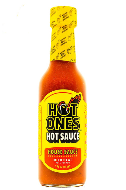 A bottle of Hot Ones House Sauce on a white background. The bottle contains a vibrant orange-red sauce and features the signature yellow and red Hot Ones label.