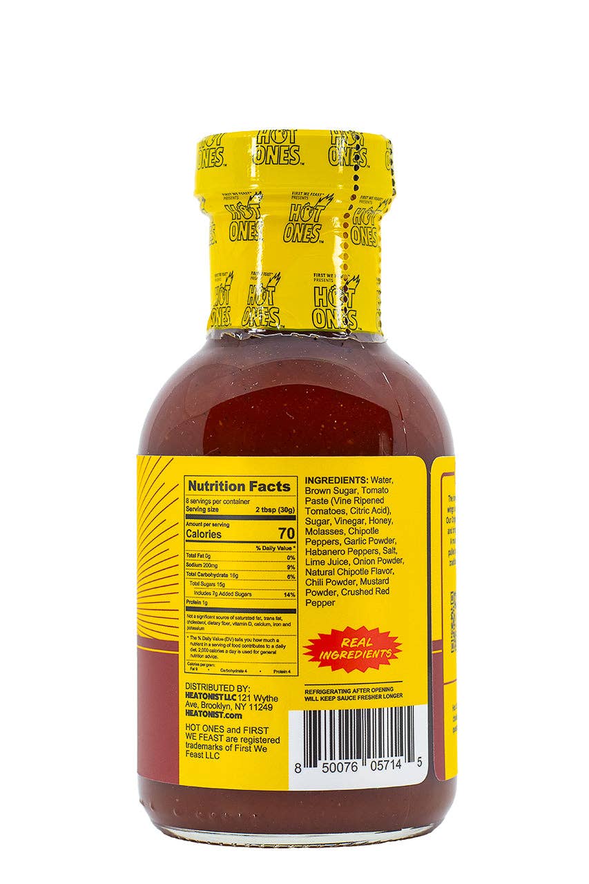 Bottle of hot sauce with yellow label and nutrition facts on a white background