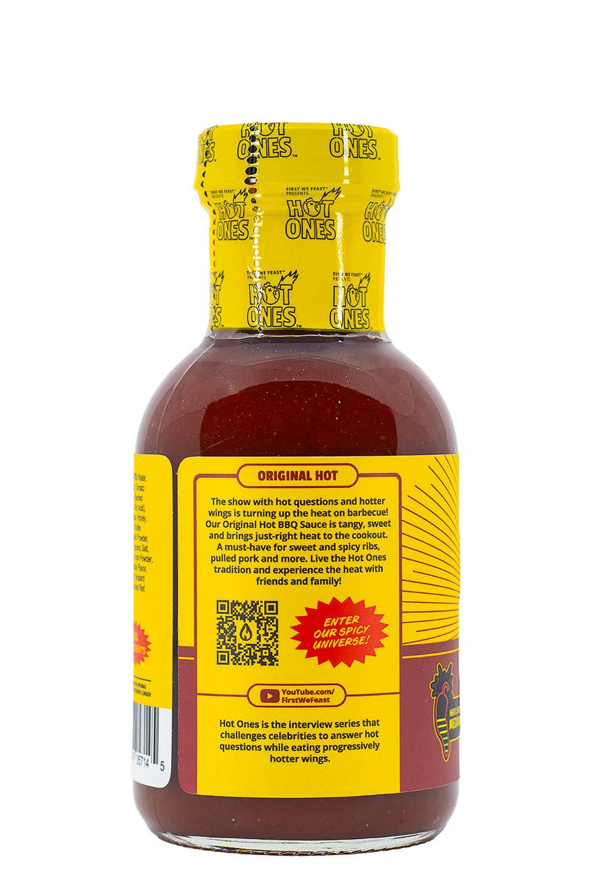 Bottle of Hot Ones hot sauce with yellow label on a white background