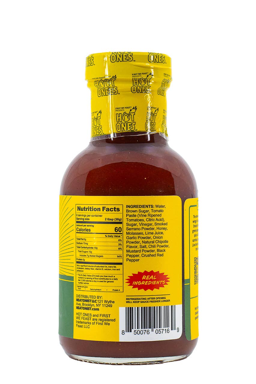 Bottle of hot sauce with yellow label and nutritional information on a white background