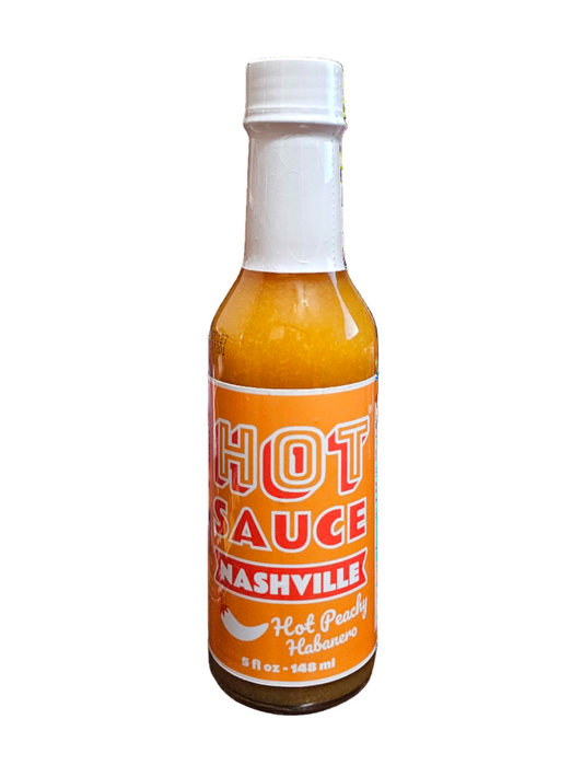 Bottle of Nashville Hot Peachy Habanero Sauce on a white background