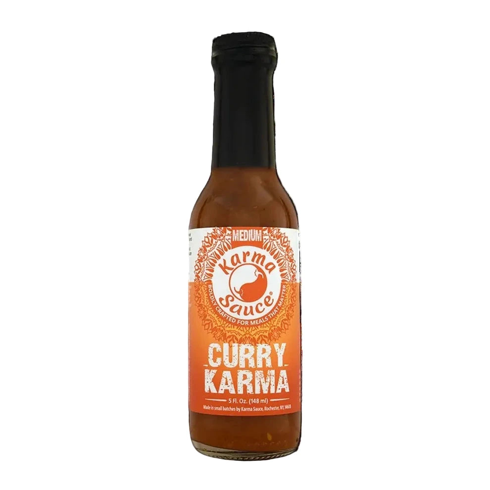Bottle of Curry Karma sauce on a white background
