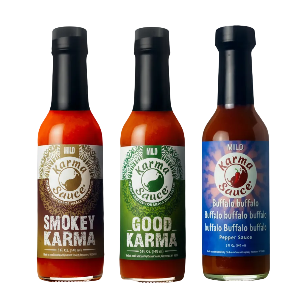Three bottles of Karma Sauce with different flavors on a gray background
