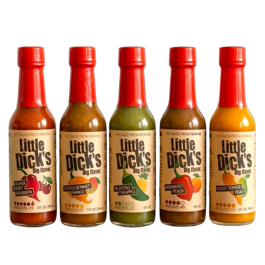 Five bottles of Little Dick's hot sauce with red caps on a white background