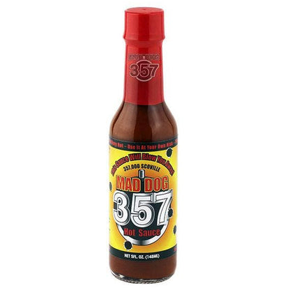 Bottle of Mad Dog 357 hot sauce with a red cap on a white background